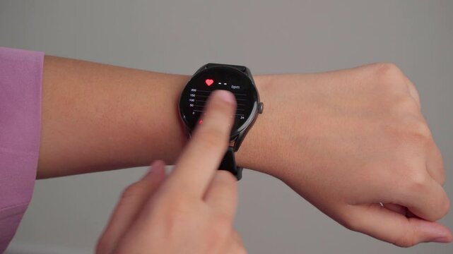Closeup Of Woman Checking Blood Pressure on Smart Watch