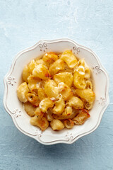Mac and cheese, the classic pasta with macaroni and Cheddar cheese, baked in the oven, shot from above