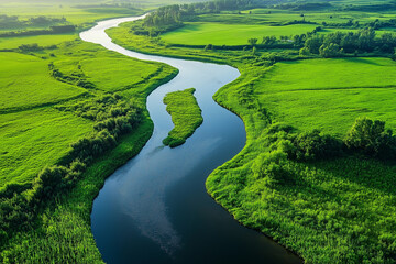Aerial view of winding river through green meadows