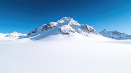 Snow-capped mountain range panorama.  Vast expanse of pristine white snow, a solitary, snow-covered mountain peak rises dramatically against a clear, cerulean sky