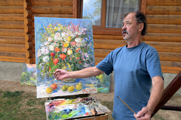 The joy of the artist upon completing a painting.