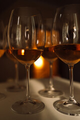Close-up of elegant champagne glasses on the table. Beautiful bokeh. Sparkling wine cups for the party.