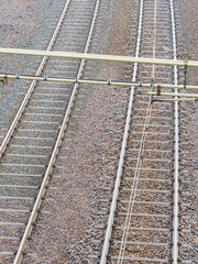 Railway tracks in Gothenburg showing gravel bed and overhead wires during a clear day
