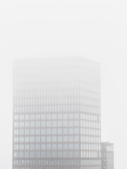 Fototapeta premium Office building in Gothenburg shrouded in misty weather on a serene day