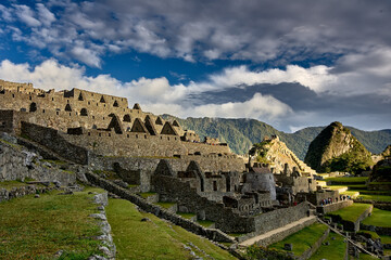 Fototapeta premium Perched high in the Andes, Machu Picchu stands as a testament to the brilliance of the Inca civilization. Surrounded by misty peaks and lush greenery, this ancient wonder inspires awe and reverence 