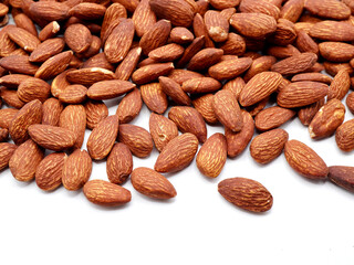 Almonds on a clean white background. Highlighting their natural brown tones and smooth, oval shapes