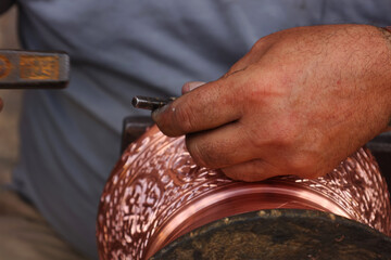 Traditional coppersmithing in Gaziantep. Craftsman engraving on a copper metal plate