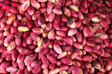 A display case of fresh pistachio fruits at a market in the city of Gaziantep. Unshelled and...