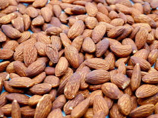A neat pile of almonds as a background, backdrop, pattern, or texture