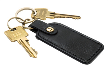 Black leather keyring with gold keys isolated on a white background