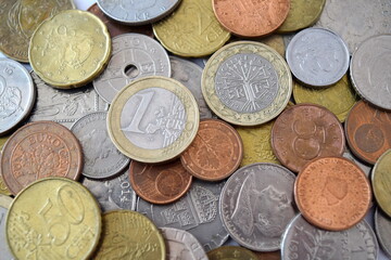 Pile of euro coins. Coins of European countries. Vatican lira, pound sterling, Norwegian krone and Swedish krona and etc.