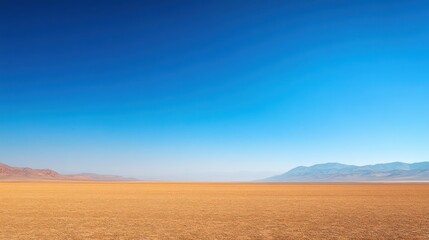 Fototapeta premium Vast expanse of arid desert under a clear blue sky evoking tranquility