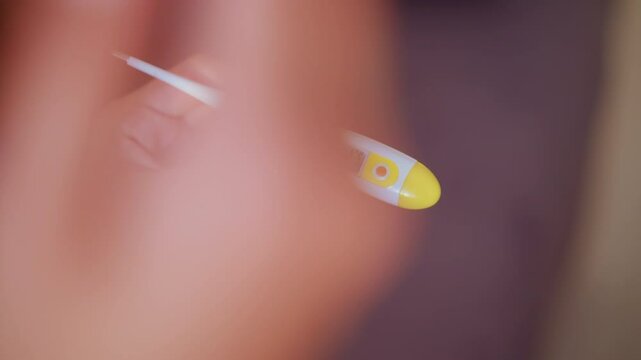 Close-up hand holding thermometer reading 41 C as person raises hand, showing high fever and discomfort, ideal for medical or health-related video projects