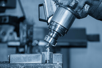 The chamfer milling process on NC milling machine with chamfer tools in the light blue scene.
