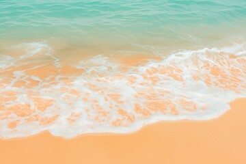 Gentle ocean waves wash up onto a beautiful sandy beach