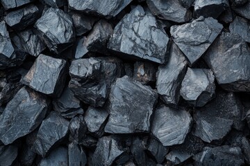Texture of stacked natural coal stones with dark shiny surface