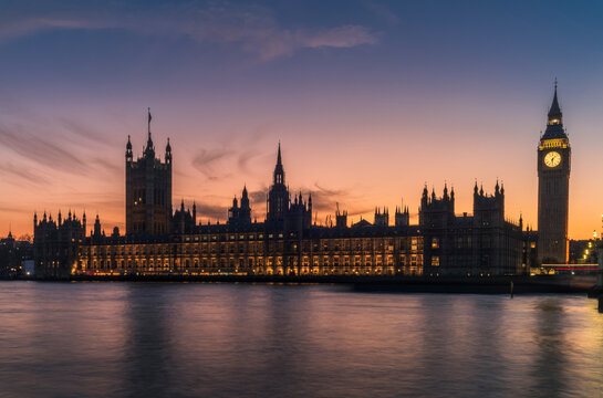 A long exposure of the Big Ben tower and the Palace of Westminster during a colorful sunset