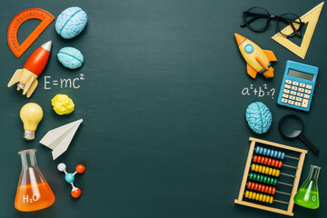 School education concept with science and math themed elements surrounding blank copyspace on green chalkboard background for creative presentation layout.