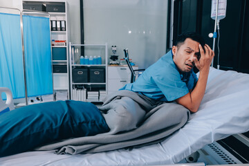 Lonely man silhouette sitting on the bed feeling depressed and stressed in the dark bedroom, Depression and anxiety disorder concept