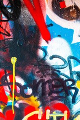 Vibrant abstract graffiti pattern featuring bold red, blue, yellow marks. Urban 90s style, colorful street art, dynamic textures. Posters, flyers, social media covers, modern creative visuals.