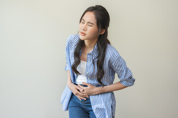 Flatulence asian young woman intolerance hand in stomach ache, suffer from food poisoning,...