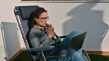 Woman Working Remotely on Laptop Outdoors in Sunglit Relaxing Setting