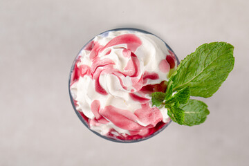 Top view on portion of sweet blueberry milkshake with whipped cream