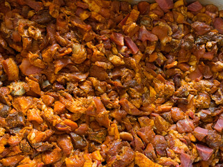 Chopped and seasoned pork meat prepared for grinding into sausages. Traditional homemade sausage making process in a rustic or farm kitchen.