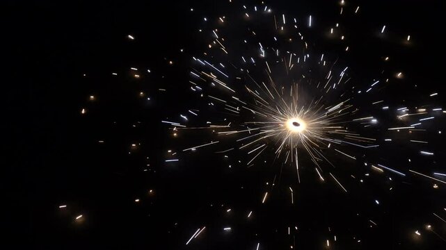A rotating sparkler or twinkling star in the dark at night. Ground Chakkar sparkler fireworks for rolling on the ground.