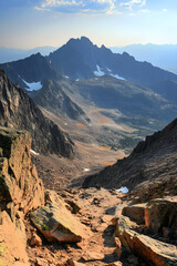 Epic Journey: Conquering Majestic Peaks in the Heart of Untamed Wilderness at Sunset