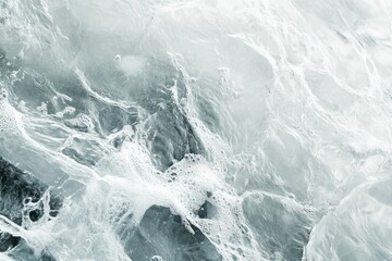 Fototapeta premium Abstract image of foamy water with swirling patterns and bubbles, creating a textured surface.
