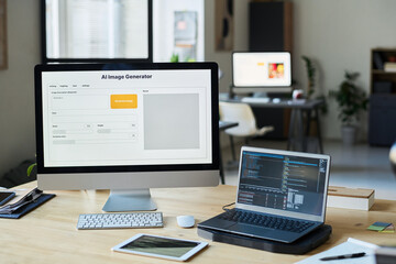 Workplace of modern designer or software developer with group of computing equipment in coworking...
