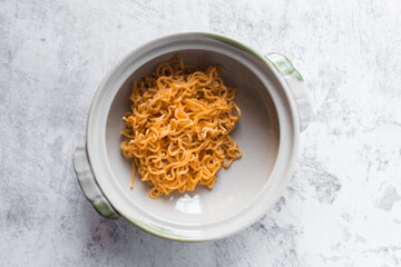 Overhead view of Spicy vegetable instant noodles in a claypot, top view of veggie ramen noodles