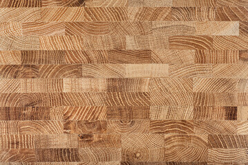 Oak wooden board as background, top view. Cross section of tree trunk. Natural durable end grain...