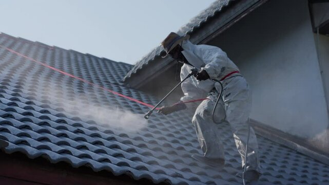 Professional painter on roof Working at heights is dangerous.	