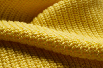 Knitted clothes. Waves of yellow fabric with a knitting pattern. Textiles. Banner for advertising goods for creativity.