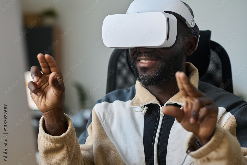 Poster young smiling african american man scrolling through virtual presentation or information in vr heads