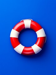 Red and White Lifebuoy on Blue Background - A classic red and white life preserver against a vibrant blue backdrop. Perfect for safety, rescue, or summer themes