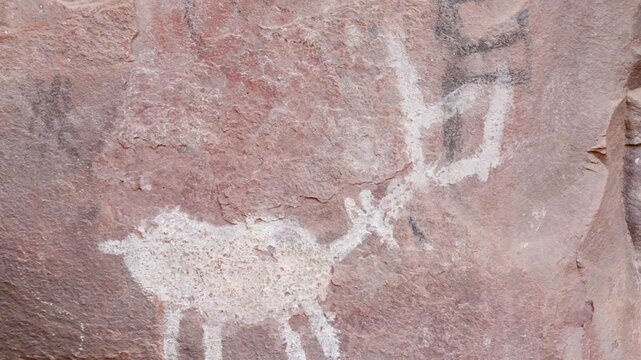 Petroglyphs adorn the sandstone walls of Palatki Ruins, revealing intricate designs created by Native American cultures. This historical site is near Sedona, Arizona