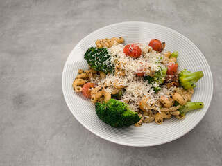 Cavatappi pasta dish garnished with broccoli and cherry tomatoes in prague copy space healthy dinner