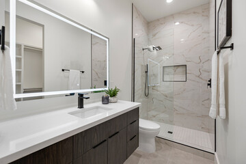 This bathroom includes a sink, toilet, shower, and mirror
