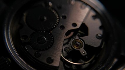 Close up of inner mechanism of a vintage watch with changing lighting