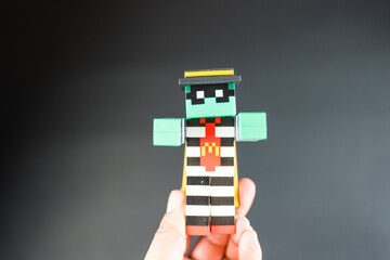 Naklejka premium Bangkok, Thailand - April 6, 2025 : Toy of Zombie hamburglar form McDonald. Blind box toy from McDonald's collaboration with Minecraft movie.
