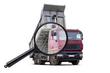 A magnifying glass is prominently displayed, examining a red truck used for equipment rental, isolated on a white background.