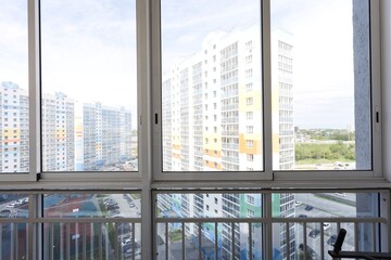 the balcony of an apartment on the upper floors of an apartment building