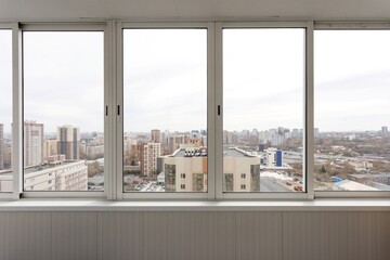 the balcony of an apartment on the upper floors of an apartment building