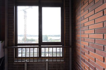 the balcony of an apartment on the upper floors of an apartment building