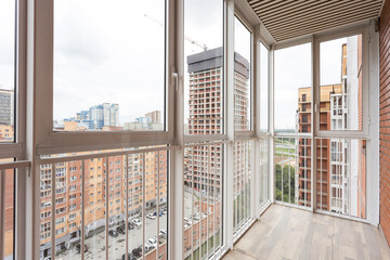 the balcony of an apartment on the upper floors of an apartment building