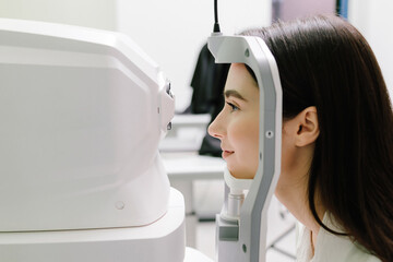 Examination of eyes of patient using optical coherence tomograph. Ophthalmologist is scanning...
