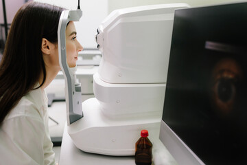 Optical coherence tomography OCT scan to create pictures of the back of eye. Examination of eyes of...